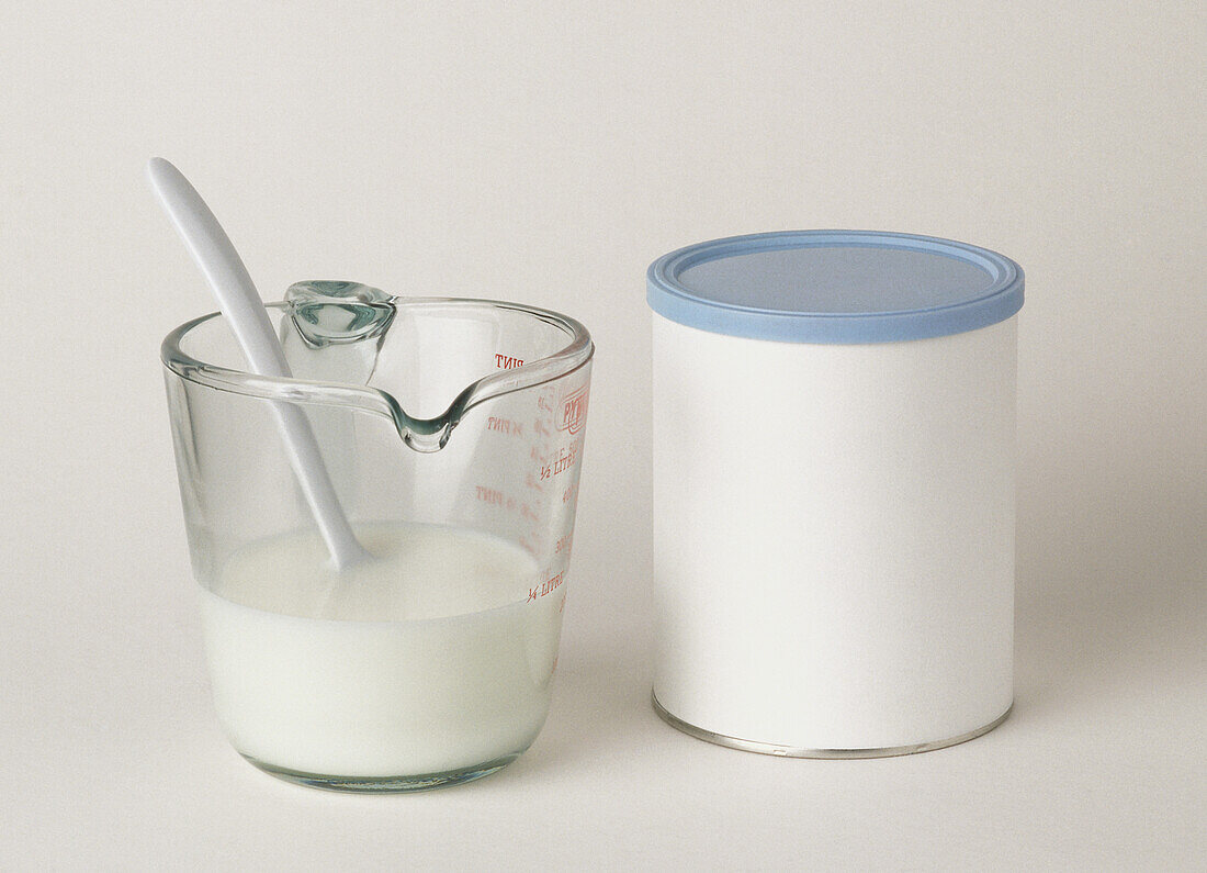 Formula milk in plastic container and glass jug