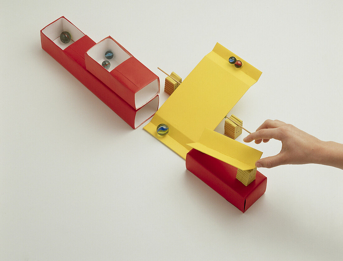 Cardboard see-Saw and chute for sorting marbles