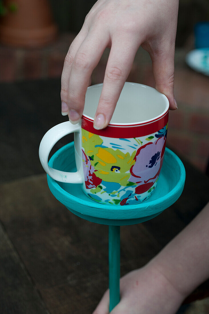 Fixing a colourful cup and saucer bird station