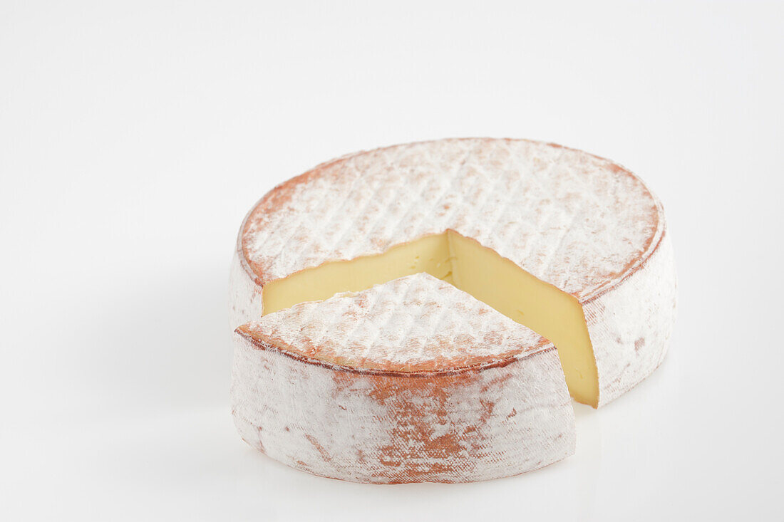 Round and slice of French Pavin cow's milk cheese