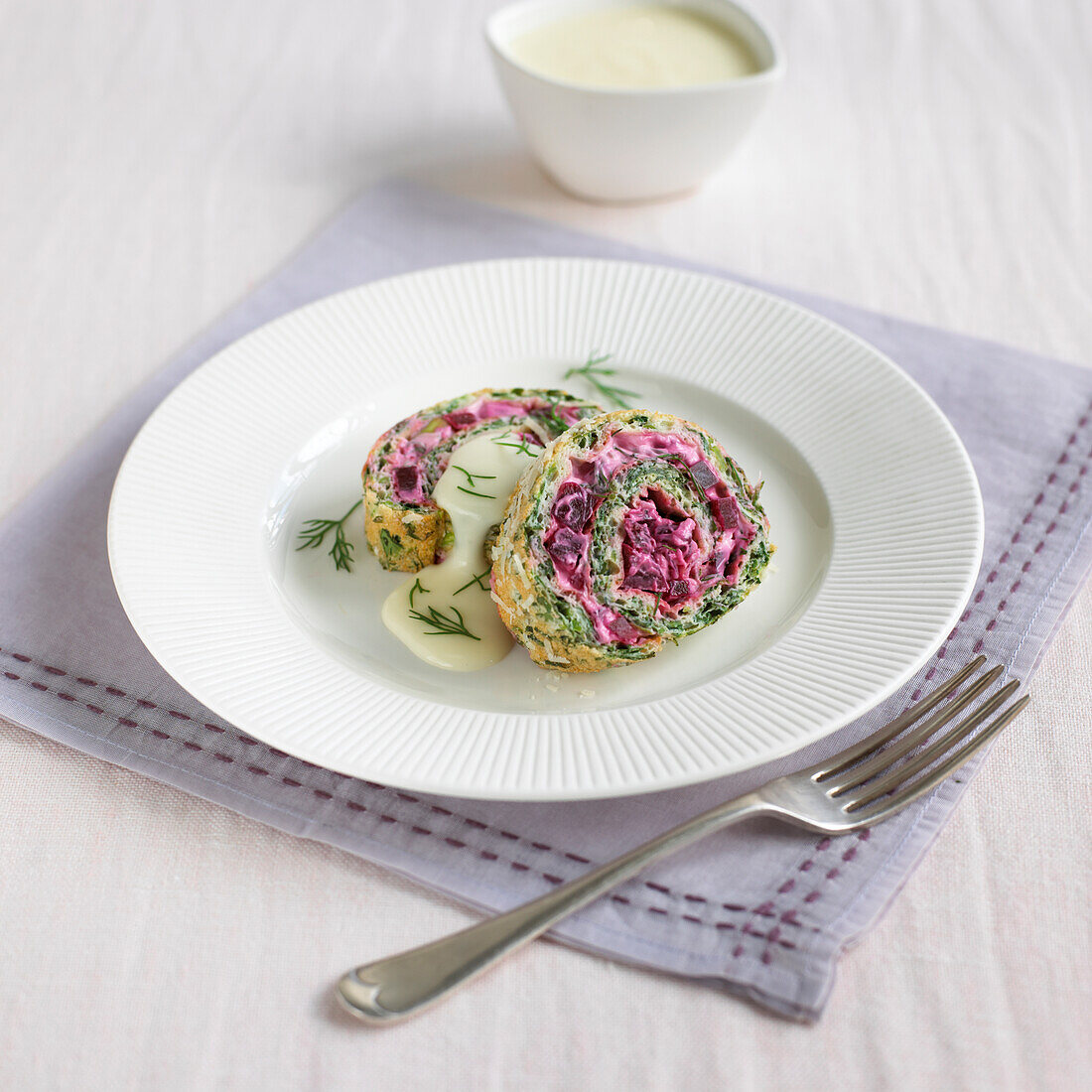 Watercress and beetroot roulade with cheese sauce