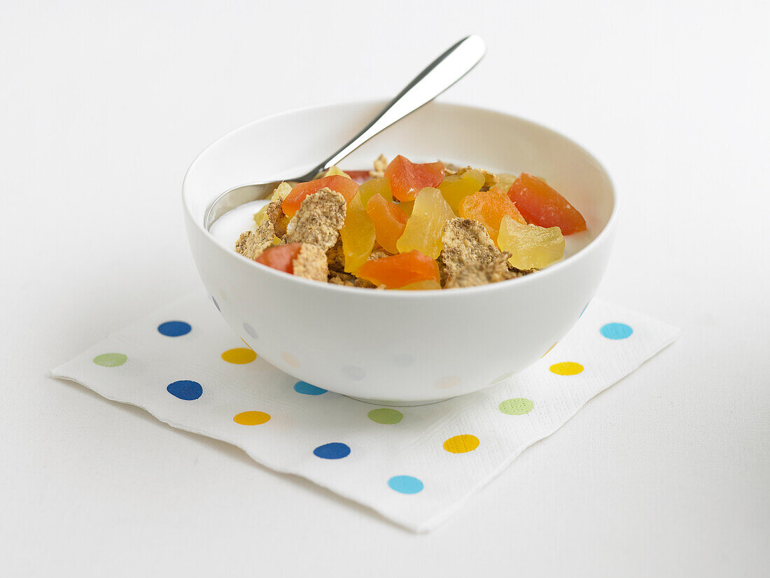 Bran flakes in bowl with milk and dried fruit