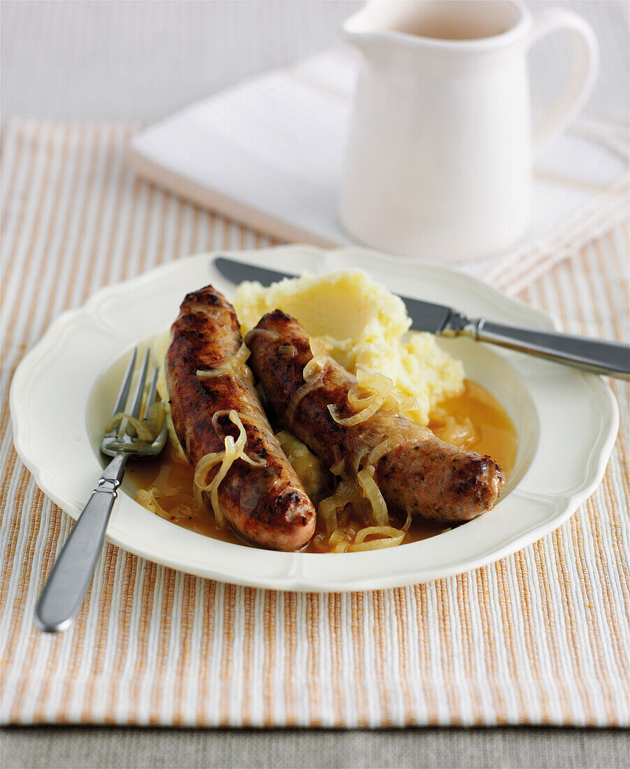 Plate of sausages with mash, onions and gravy