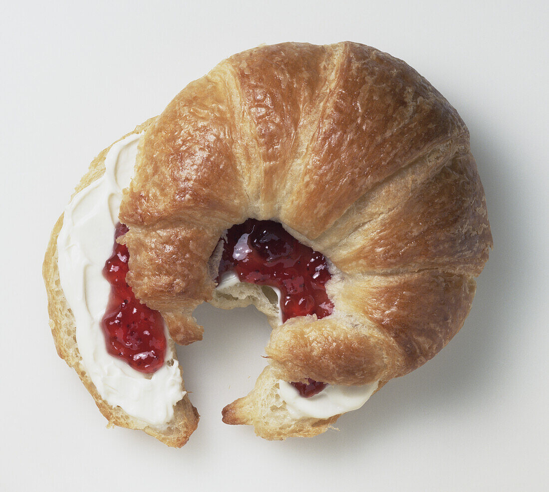 Croissant filled with creme fraiche and strawberry jam