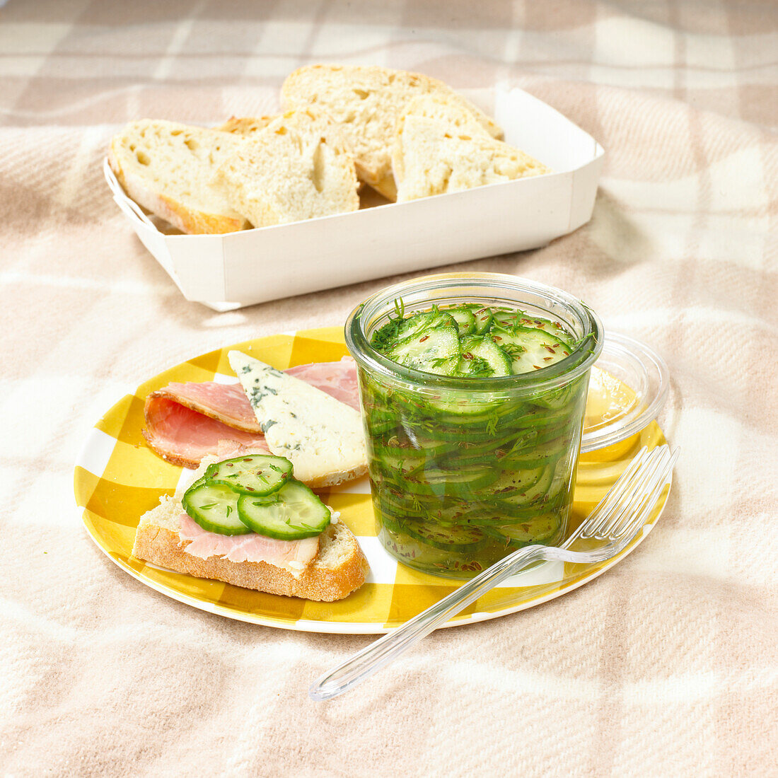Ham and sliced bread and jar of cucumber and dill pickle