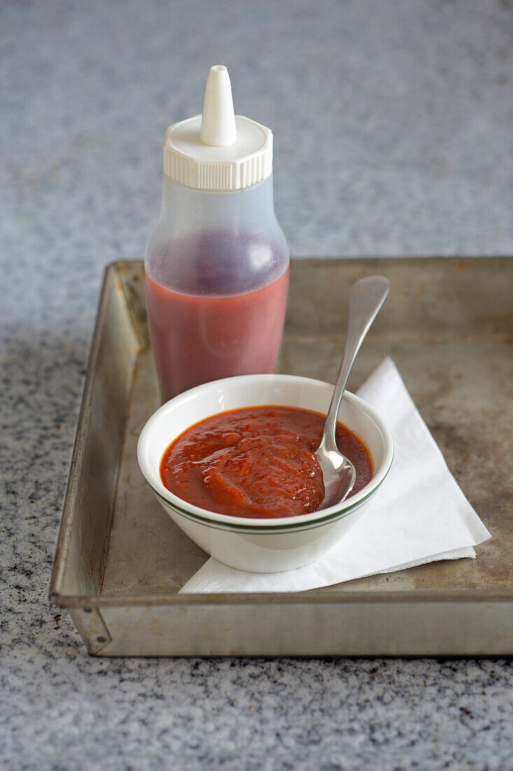 Cherry tomato and onion relish with savoury sauce on tray