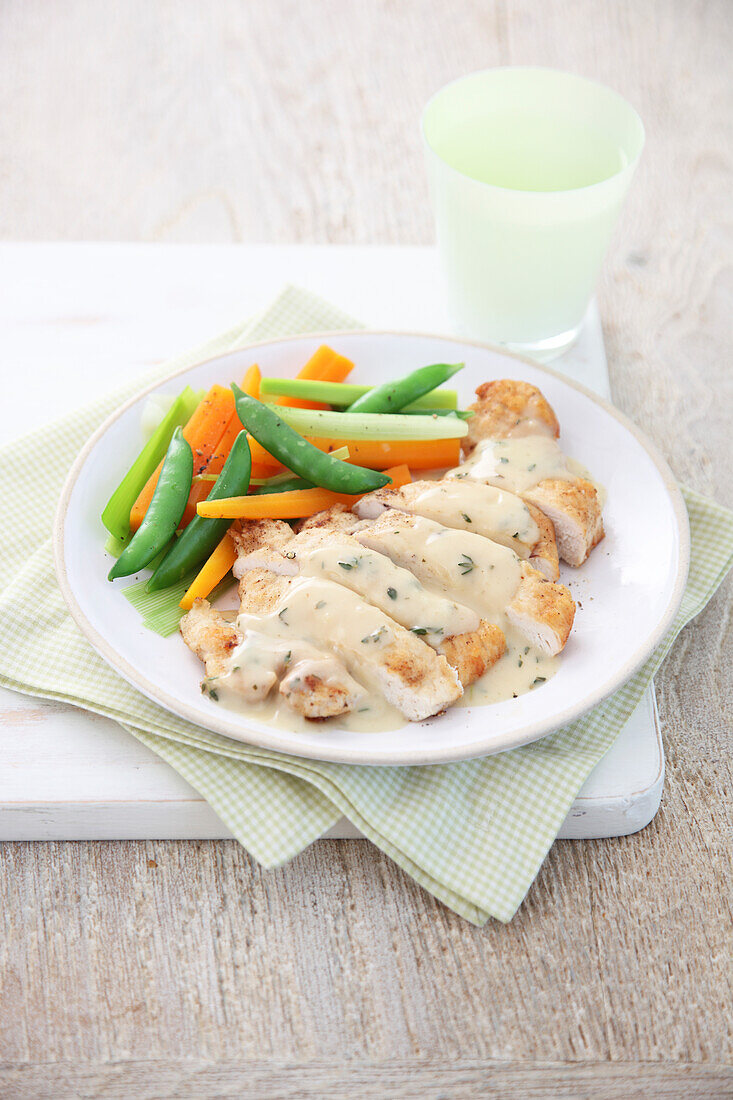 Chicken escalope in lemon sauce with carrots and mangetout