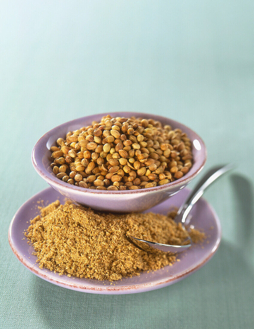 Bowls of coriander seeds and powdered coriander