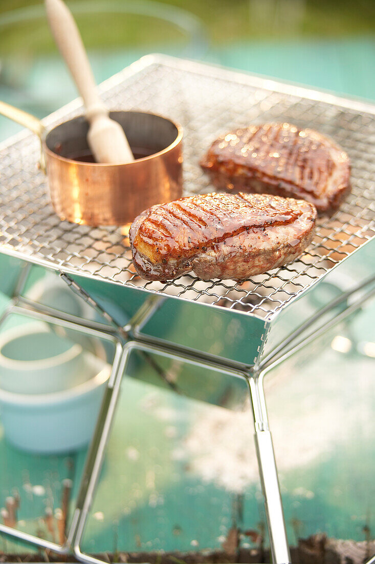 Duck breast with orange-cardamom glaze on barbeque grill