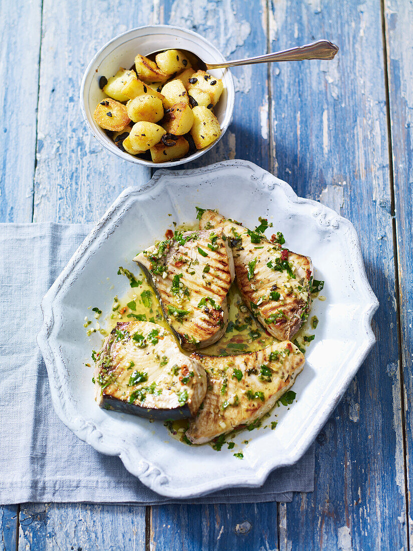 Grilled swordfish served with potatoes