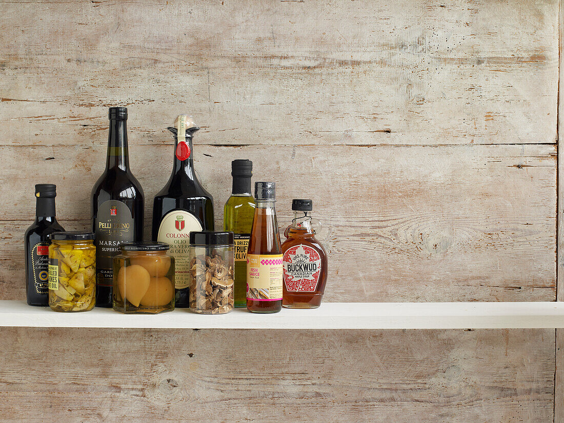 Various cooking ingredients in bottles and jars on shelf