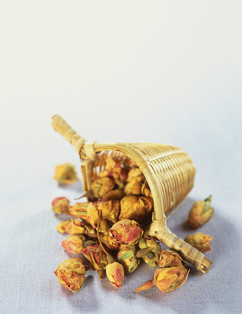 Rose buds spilling out from small raffia basket