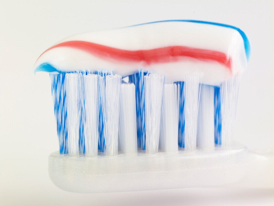 Striped toothpaste on a toothbrush head