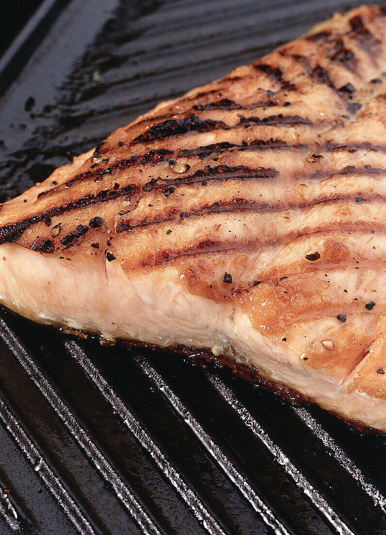Grilled salmon fillet on a griddle plate