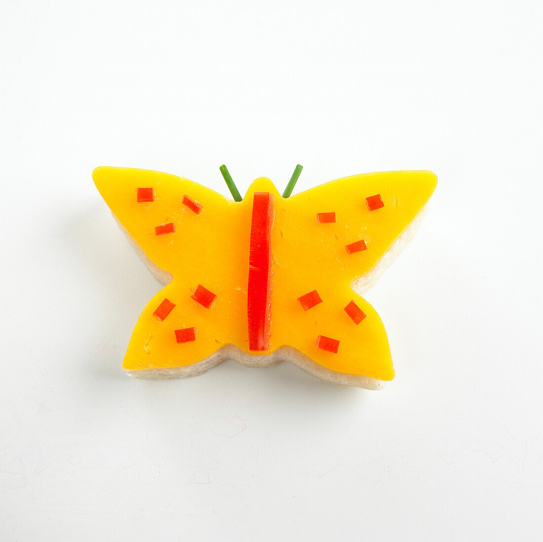 Butterfly-shaped cheese sandwich with peppers for decoration