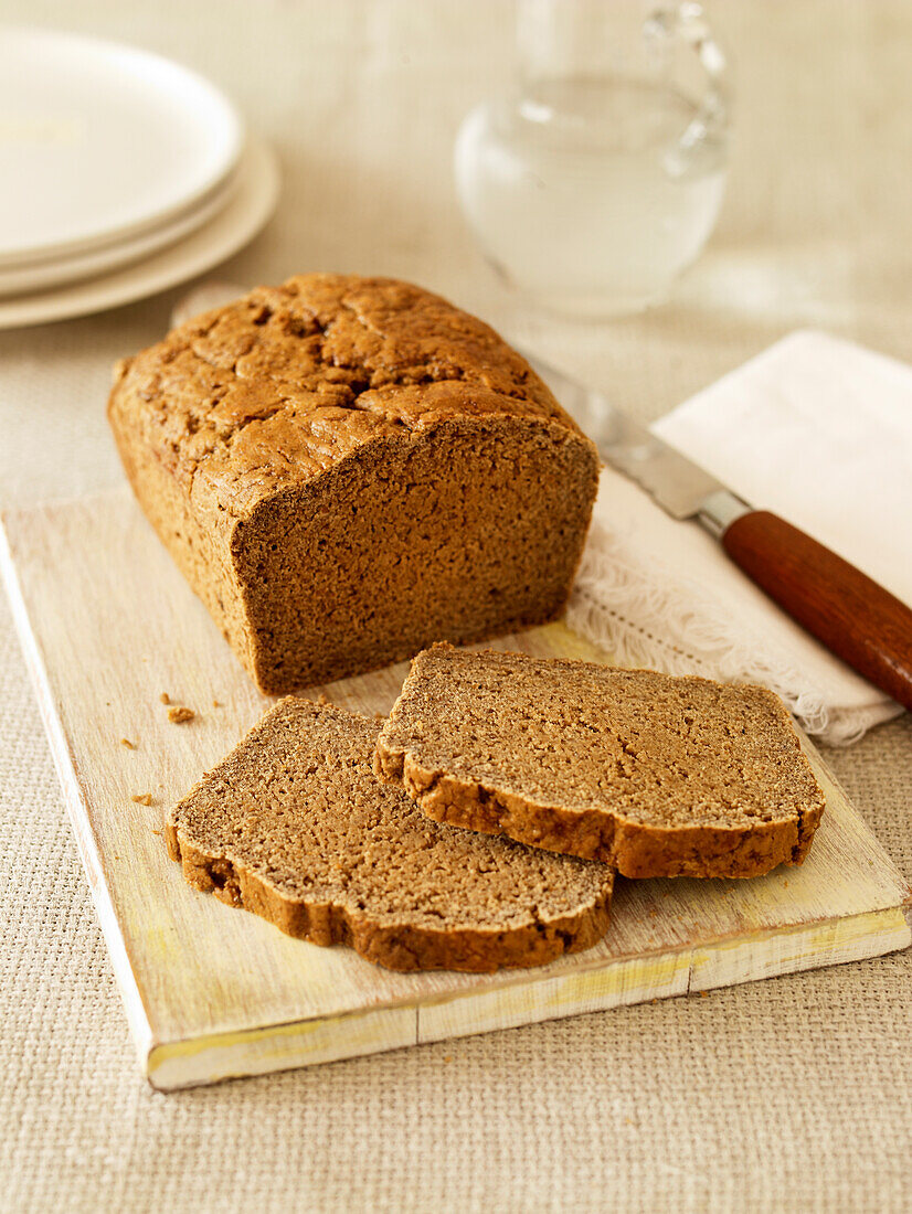 Gluten free basic brown loaf on chopping board