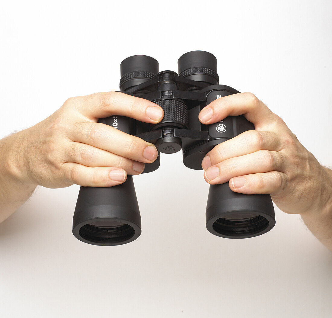 Hands holding binoculars
