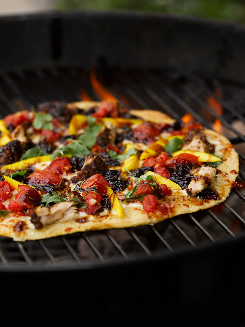 Pizza on charcoal grill