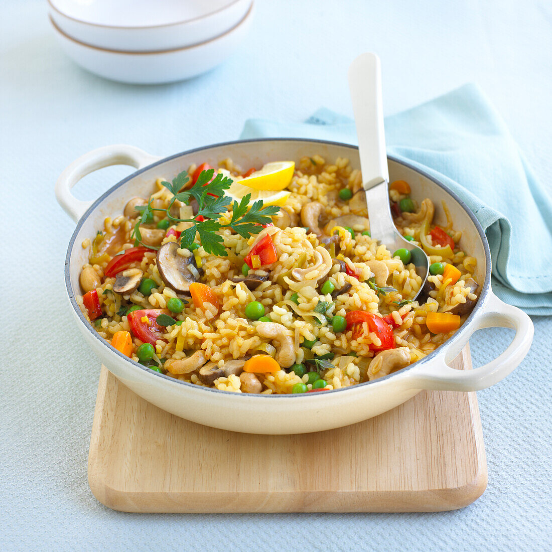 Cashew nut paella with peas, mushroom, carrots, and tomatoes