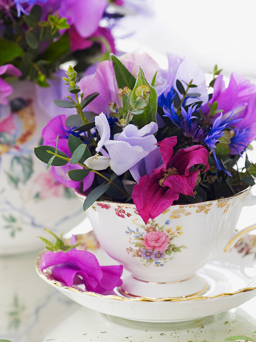 Flowers arranged in floral vintage tea set