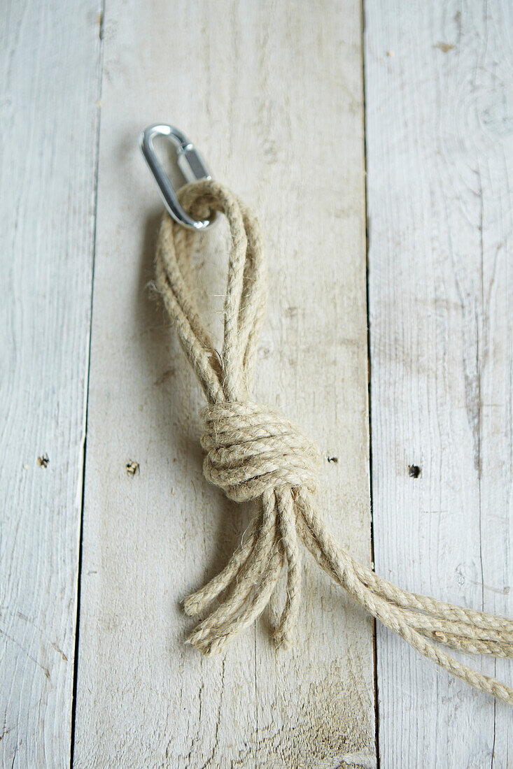 Rope gathered tied in strong knot attached to metal loop