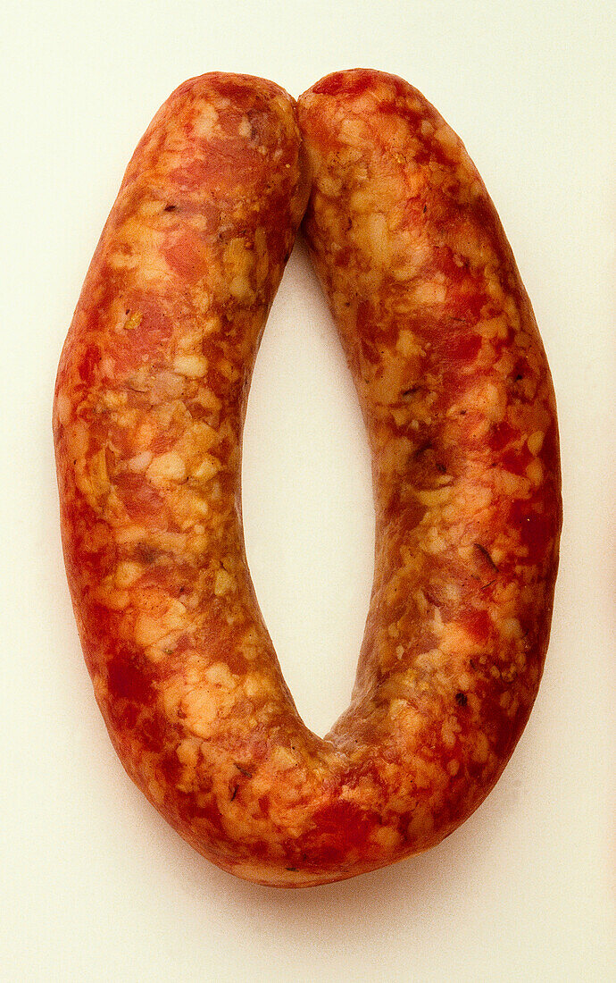 Reddish brown and yellow mottled length of Toulouse sausage