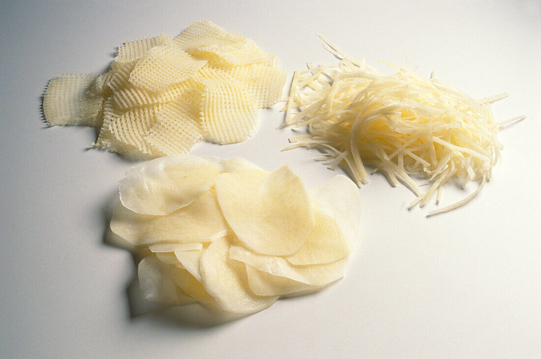 Three piles of potatoes cut in different ways