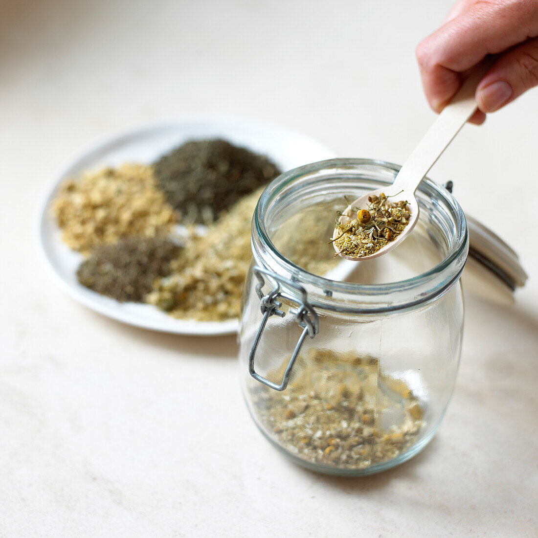 Spoon containing dry ground pepper, mint and thyme