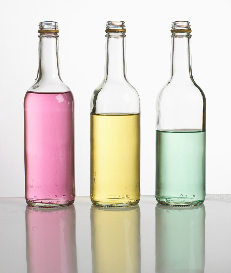 Bottles filled with different amounts of coloured water