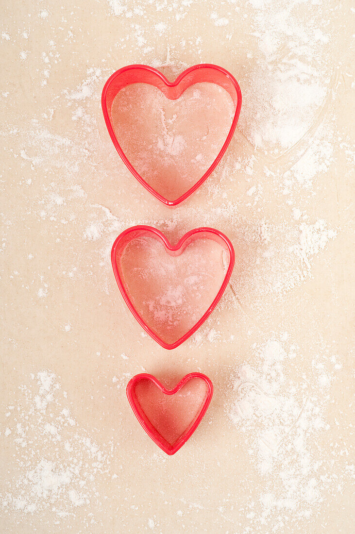 Heart-shaped pastry cutters on pastry