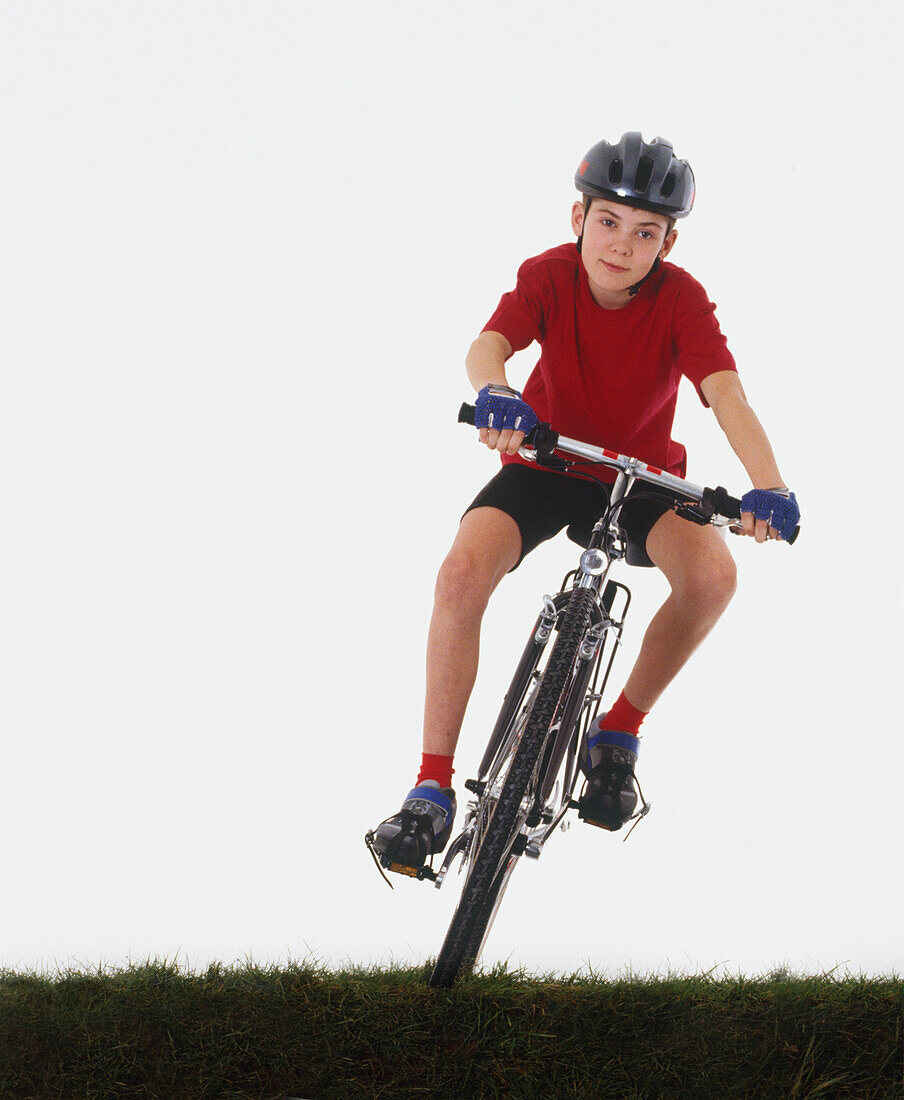 Child cycling on grass
