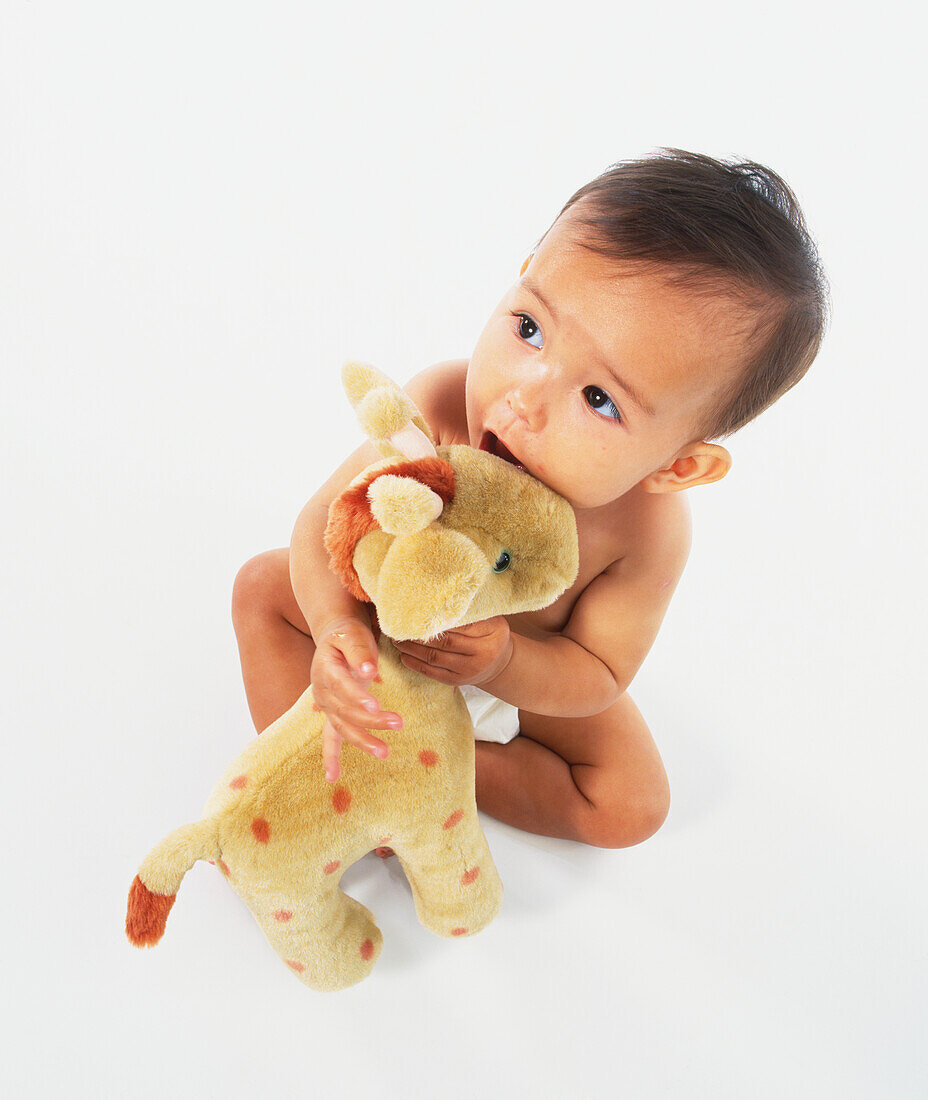 Baby holding a toy giraffe