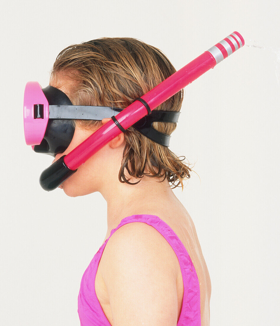 Girl wearing pink mask and snorkel