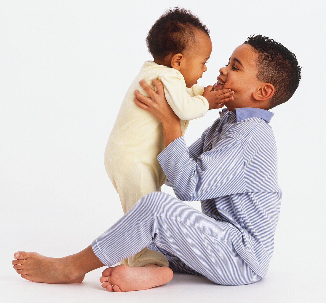 Boy holding a baby boy