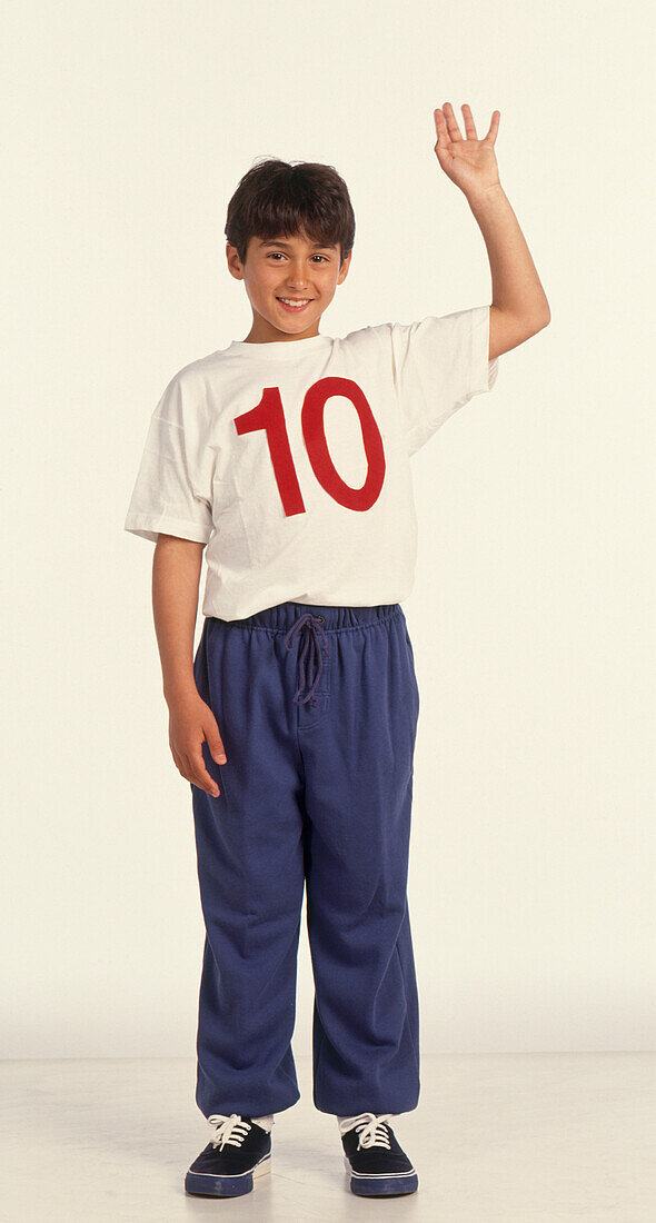 Boy wearing a white t-shirt with a red number ten on it