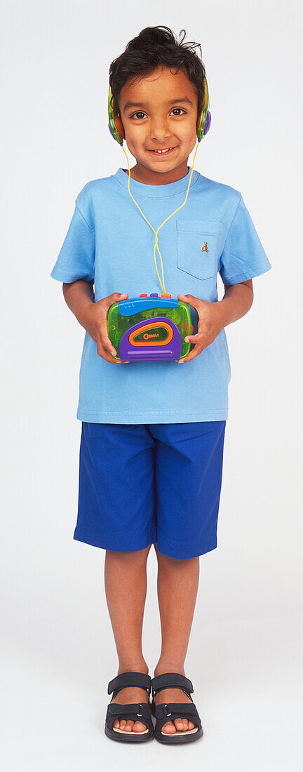Boy holding walkman and wearing headphones