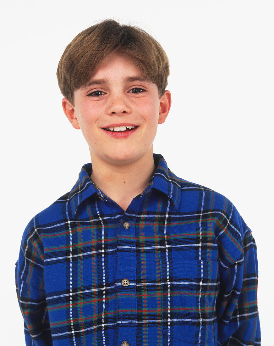 Smiling brown-haired boy in blue tartan shirt