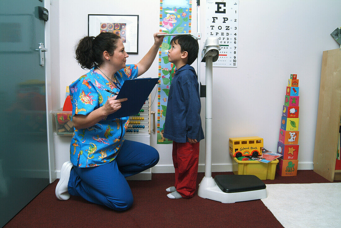 Nurse measuring a boy's height