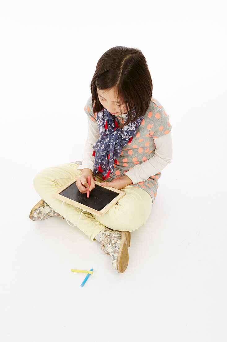 Girl sitting using tablet