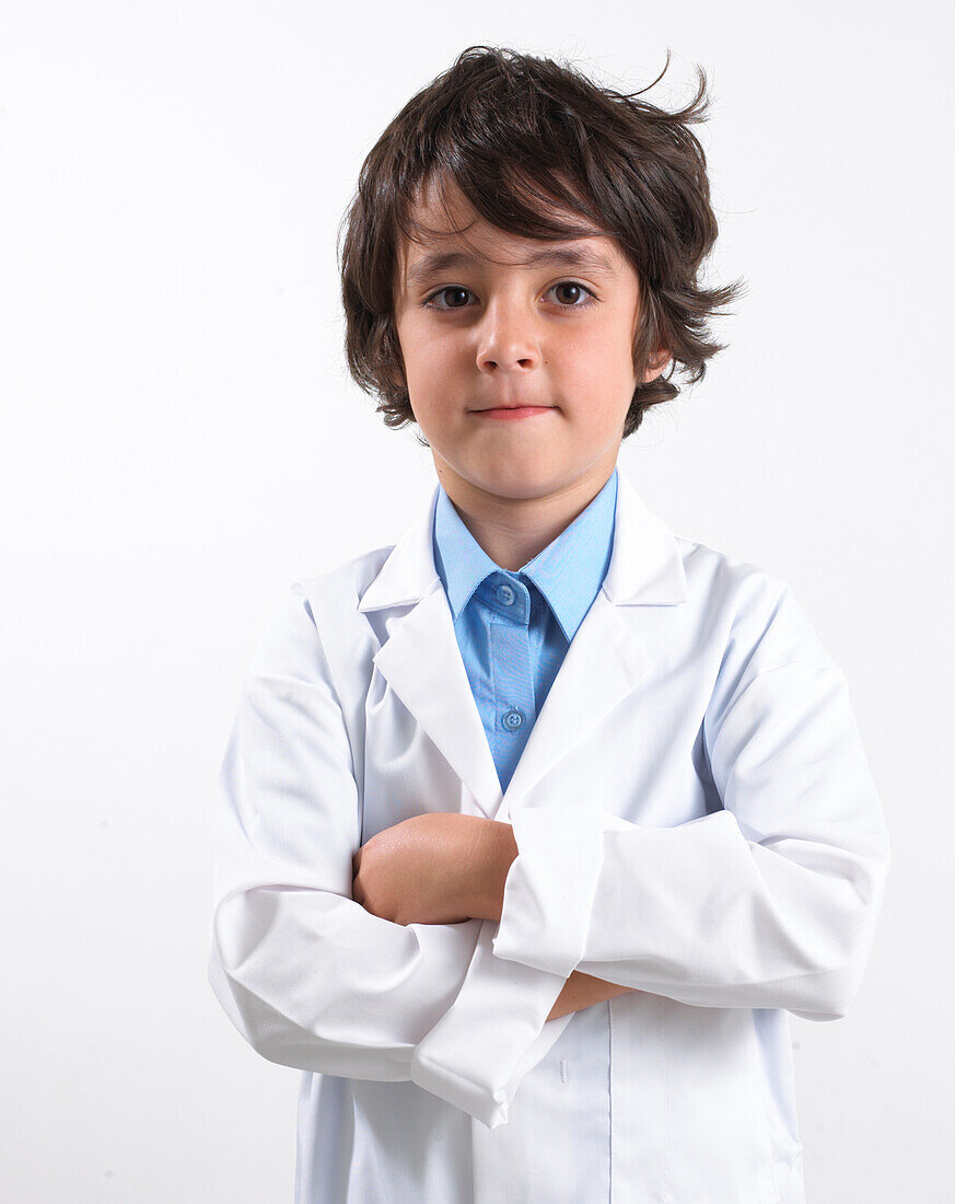 Boy wearing white coat with arms folded