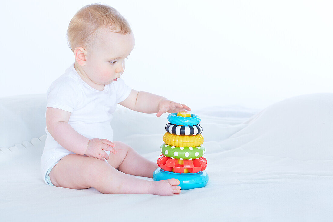 Baby boy playing with stacking toy