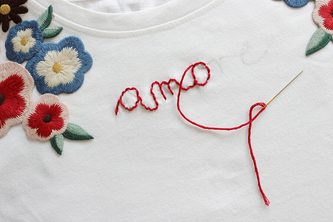 Embroidered flowers and the word 'amore'.