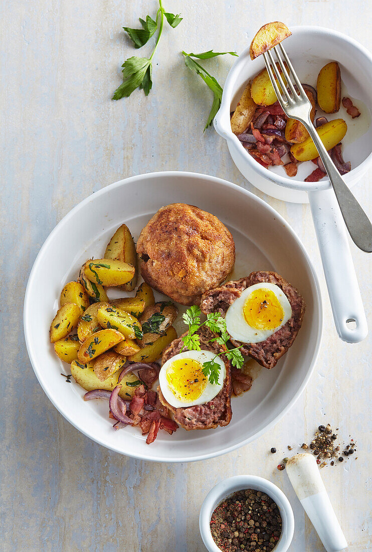 Scotch eggs with fried potatoes