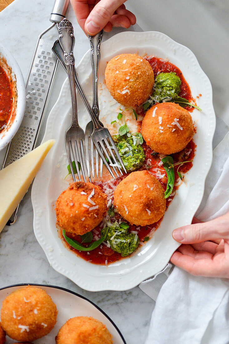 Arancini with tomatoes on a dish
