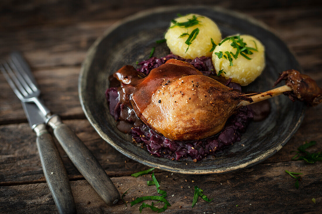 Duck leg with red cabbage and potato dumplings