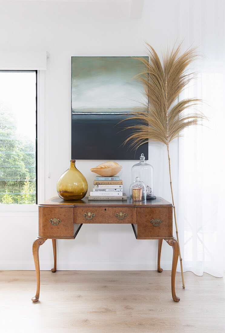 Antique desk, palm frond and landscape painting