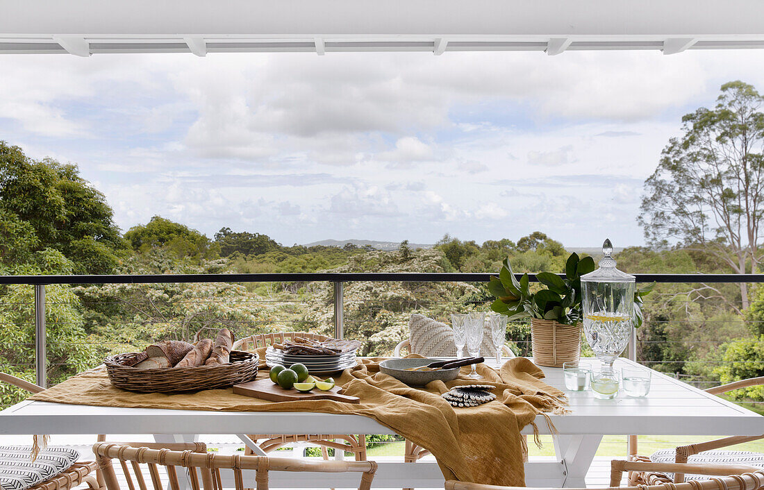 Dining table on covered terrace with landscape view