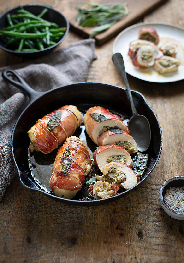 Stuffed chicken breas with sage and wrapped in prosciutto