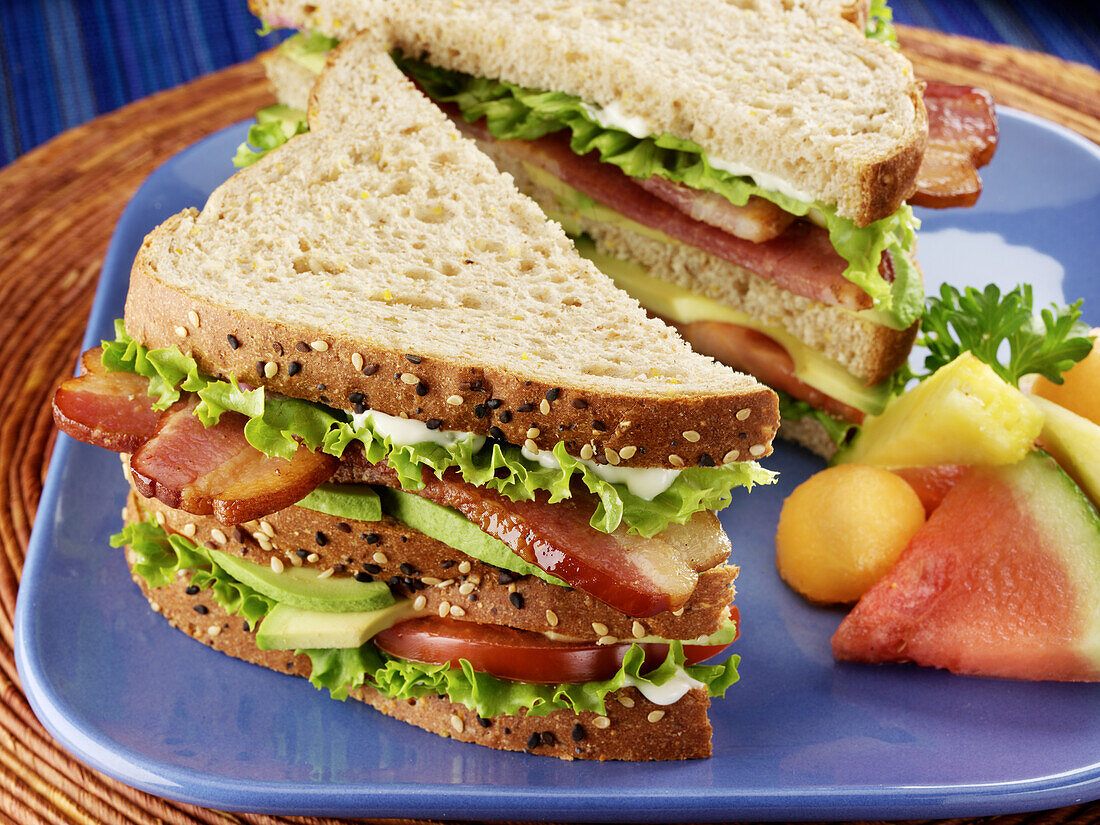 BLT - bacon, lettuce, tomato and avocado club sandwich on whole grain bread