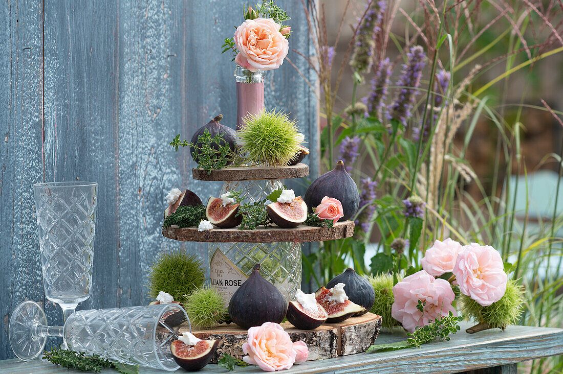 Make your own etagere from a bottle and wooden discs: Rose petals, citrus thyme, figs whole and sliced with ricotta, chestnuts in the fruit shell, champagne glasses